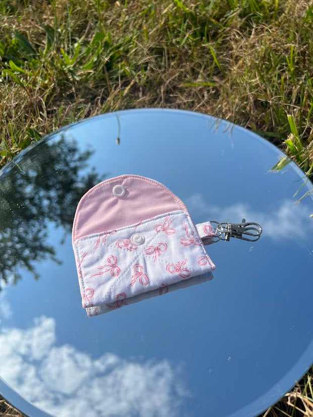 Scattered pink bow AirPod case